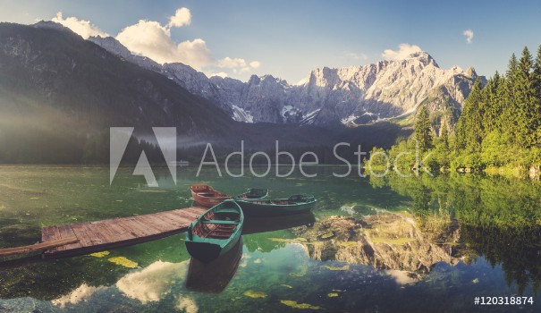 Bild på Alpine lake at dawn beautifully lit mountains retro colors vintage